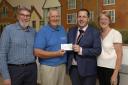 David Beedle presented a cheque to musical director James Cairns, treasurer Gerry Bassingthwaighte and chair Lucy Myers