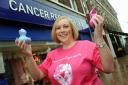 Breast cancer survivor Angela Lavery poses with Cancer Research UK's new limited edition 'designer' rubber ducks as part of Breast Cancer Awareness Month