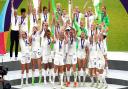 England's Leah Williamson and Millie Bright lift the trophy with team-mates after winning the UEFA Women's Euro 2022 final at Wembley Stadium