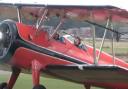 Tom Cruise in a Boeing Stearman biplane at Duxford Airfield.