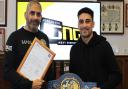 Jordan Gill with father Paul (left) and the European featherweight title won in February.