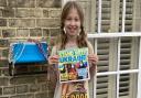 Rosa, 10, outside her home near the river in Ely making and selling bracelets to support Ukraine.