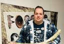 Jamie Jordan with the mammoth tusk found near Peterborough.