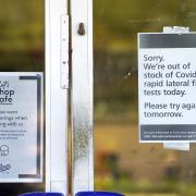 A sign informing customers that there are no lateral flow test kits available on the door of a pharmacy Picture date: Wednesday January 5, 2022.