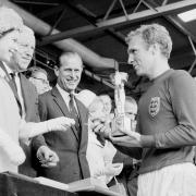 England captain Bobby Moore receives the Jules Rimet Trophy from Queen Elizabeth II after the 1966 World Cup final at Wembley Stadium