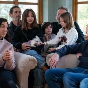 Mick Swinhoe (right) talks to Valeriia Starkova and her family as they settle into their new home in Caldecote near Cambridge, which the four-generation family of 10 moved into last week after they fled Kharkiv in the Ukraine following the Russian