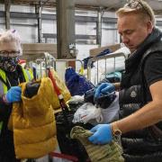 Ross Taylor (right) helping out inside Ukraine Lifeline's main warehouse in Pymoor.