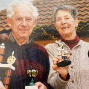 Pamela Newton (right) with husband John and some of the bowls trophies they won in the UK.