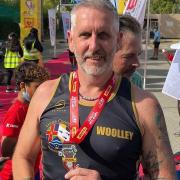 Andi Woolley is flying the Three Counties Running Club high as he competed in an Ironman event in Bahrain.