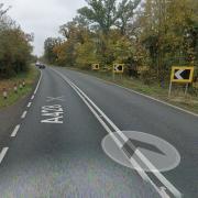 The A428 near St Neots has been blocked in both directions following a collision between a lorry and a car that caused an oil spill.