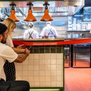 Bread Hospitality founder Tom Ginn and his daughter Huxley cut the ribbon at the grand opening of Toast Kitchen and MILK at Yalm food hall in Norwich