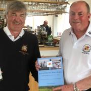 St Ives captain Jon Vallis (R) presented March captain Gareth Clark (L) with a copy of the book written to celebrate 100 years of golf at St Ives.