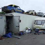 A huge blaze in Wisbech led to the discovery of almost £700,000 worth of cannabis in a scrapyard and warehouse, including hundreds of plants growing inside lorry trailers.